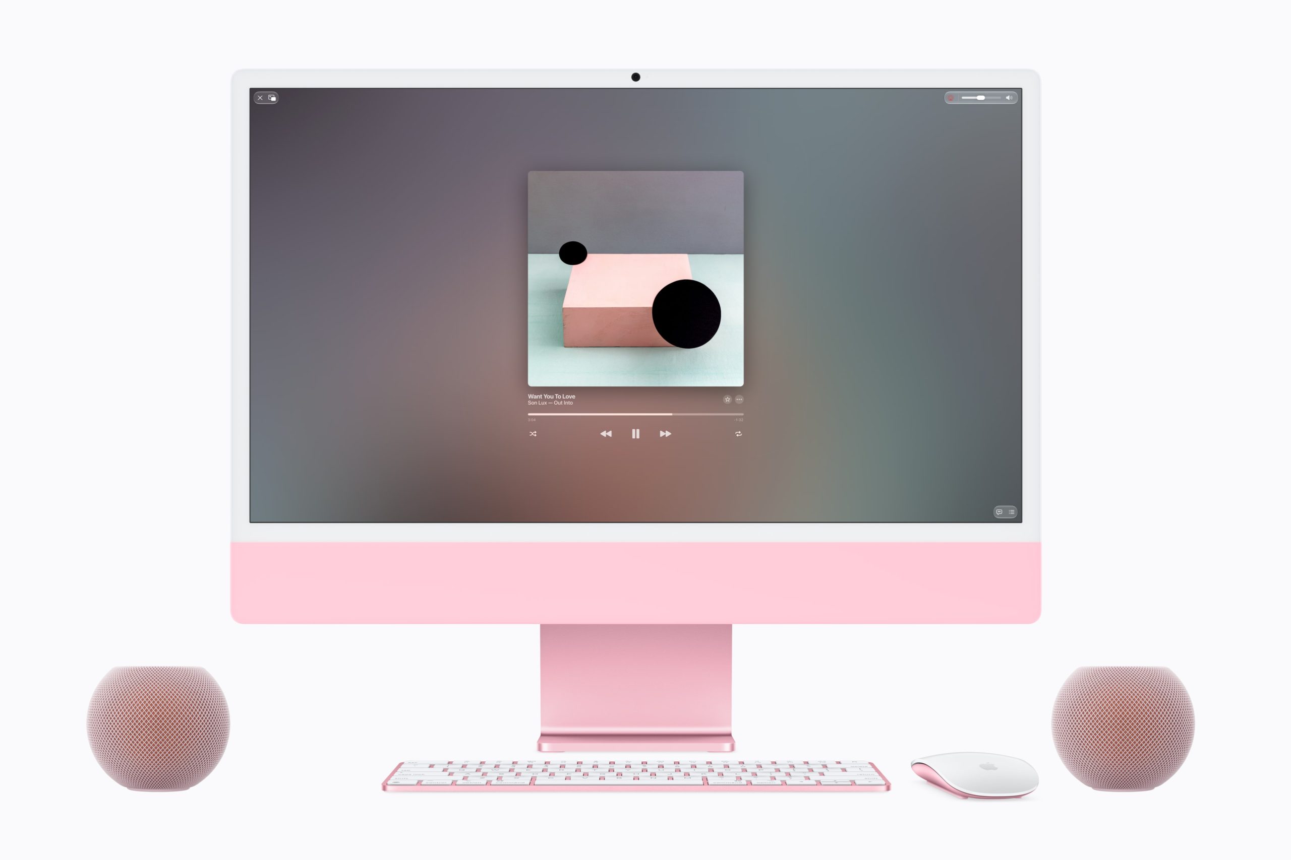 Dos HomePod mini 2 en color rosa junto a una iMac a juego